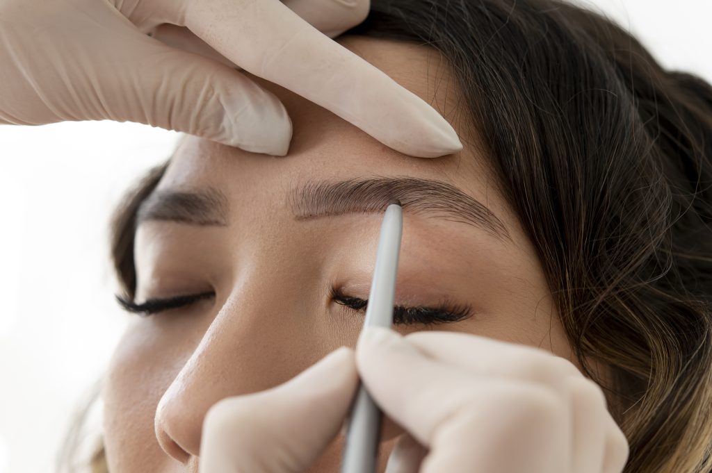 young-female-client-going-through-microblading-procedure